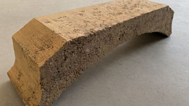 Interior wall constructed with Fetdeterra unbaked compressed earth blocks, demonstrating structural thermal mass and natural clay textures without synthetic finishes.