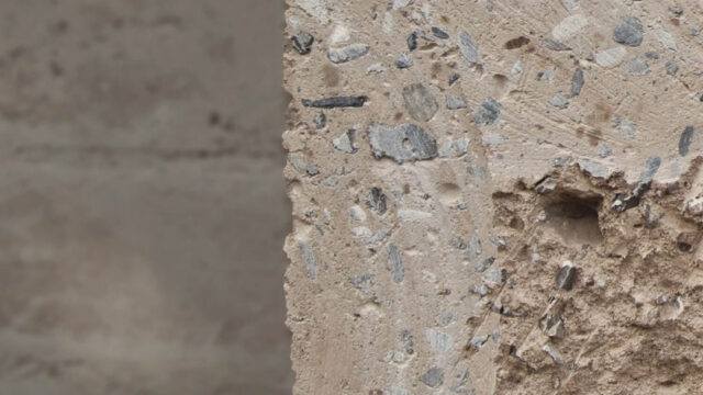 Interior wall constructed with Fetdeterra unbaked compressed earth blocks, demonstrating structural thermal mass and natural clay textures without synthetic finishes.