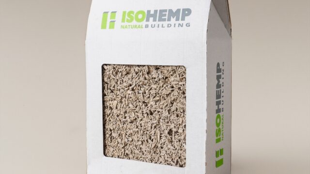 Timber frame construction utilizing IsoHemp hemp-lime masonry blocks for carbon-negative, vapor-permeable thermal insulation.