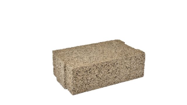Timber frame construction utilizing IsoHemp hemp-lime masonry blocks for carbon-negative, vapor-permeable thermal insulation.