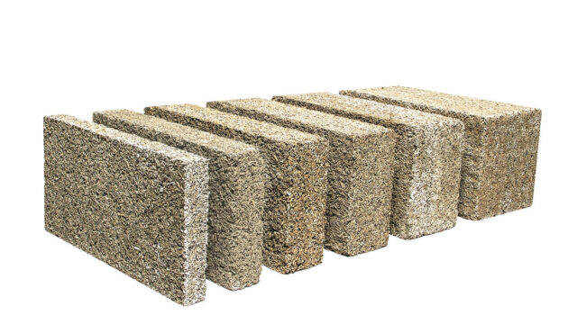 Timber frame construction utilizing IsoHemp hemp-lime masonry blocks for carbon-negative, vapor-permeable thermal insulation.