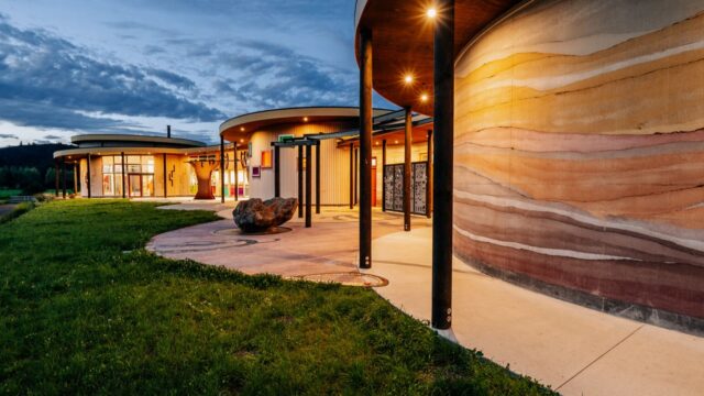 Load-bearing structural insulated rammed earth wall by SIREWALL, demonstrating geological stratification and high compressive strength.
