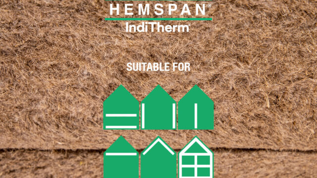Installer placing a flexible IndiTherm hemp insulation batt (friction fit) between timber structural framing.