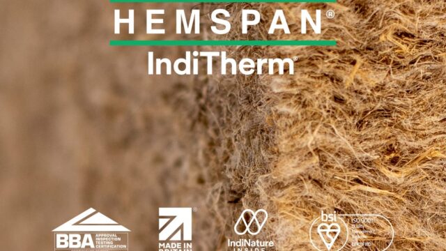 Installer placing a flexible IndiTherm hemp insulation batt (friction fit) between timber structural framing.