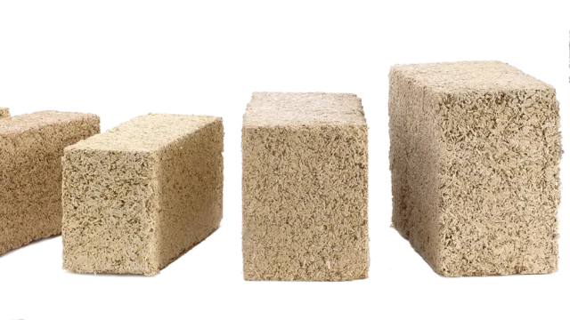 Biomattone® pre-cast hempcrete blocks stacked on a construction site, ready for dry assembly as a biogenic infill wall.