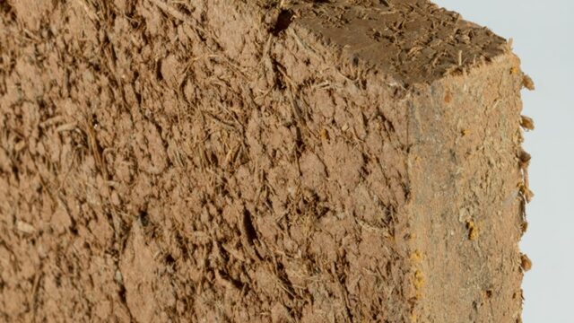 Claytec dry building boards installed on an interior stud frame, replacing traditional synthetic gypsum drywall with a raw earth bio-composite.