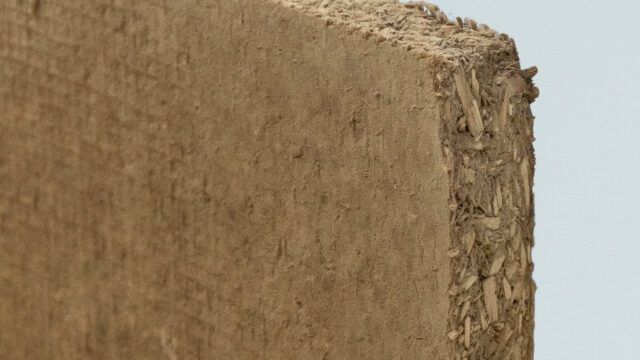 Claytec dry building boards installed on an interior stud frame, replacing traditional synthetic gypsum drywall with a raw earth bio-composite.