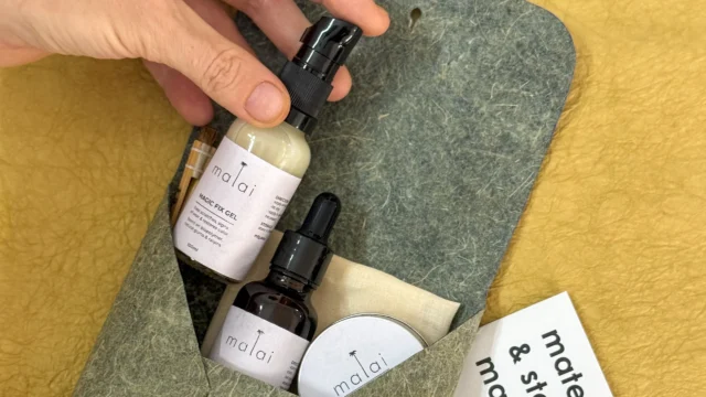 Flexible sheets of Malai bio-composite, created from coconut water-derived bacterial cellulose and natural fibers, showcasing an organic, leather-like texture.